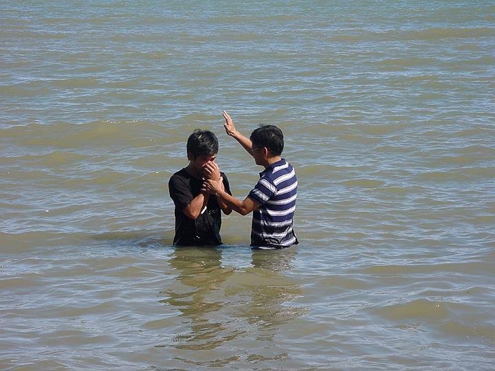 Elder Tadea baptizing Jay-R Bayawan